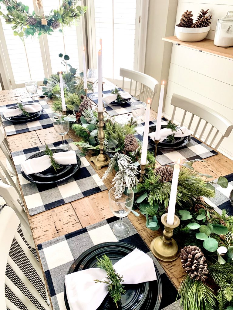 Christmas table setting with placemats and garland.
